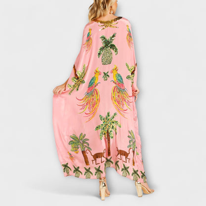 Linda - Iøynefallende kjole med av-shoulder design og kokosnøtttre trykk